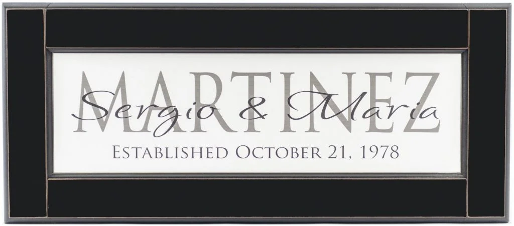 Personalized wood framed Sign White wood sign with charcoal family name framed in black wood frame with couple's names and established date in black complete view