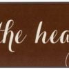 Chocolate wooden kitchen sign with the text "The Kitchen is the Heart of the Home" in off white text through the middle of the sign