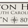 Latitude and Longitude wooden sign with the Hilton Head South Carolina along the top of the sign as well as the latitude and longitude coordinates along the bottom of the sign black text