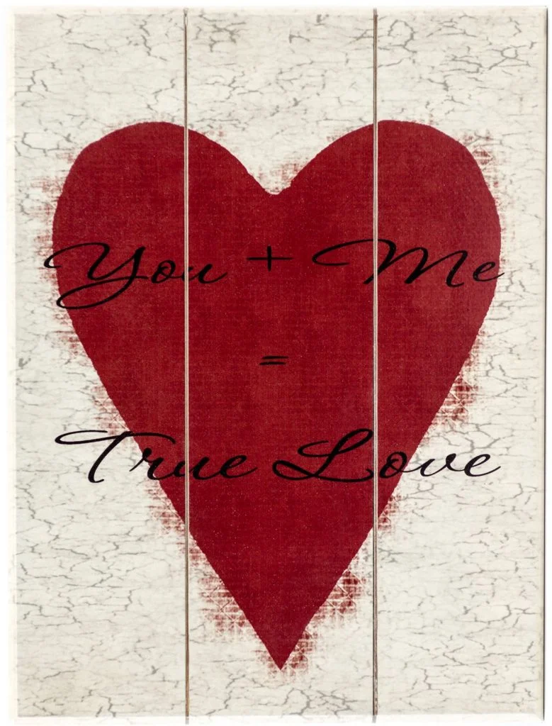 Vertical Valentine's Day holiday wood sign with saying, "You + Me = True Love" on off white plaque with red heart.