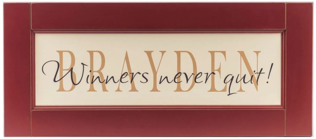 Personalized name sign framed in a red wood frame for boys bedroom wall decor.