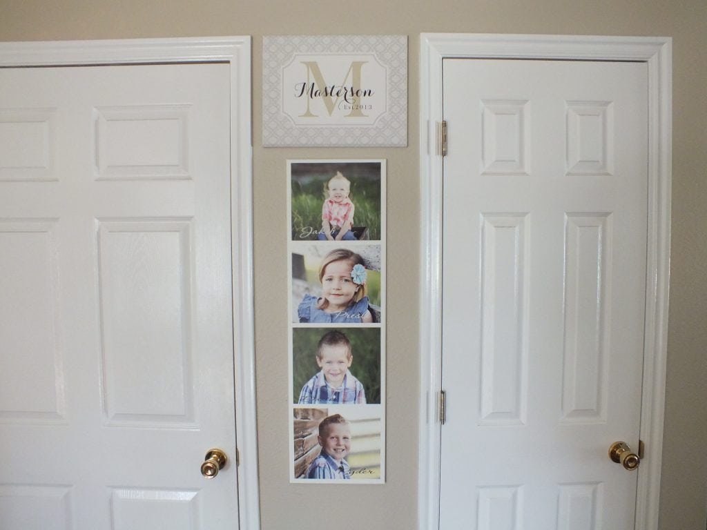 wooden monogram sign on display at home above vertical wood photo collage